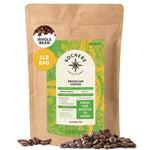 A 1-pound bag of Kochere Coffee Brazilian Santos Medium Roast from Kochere Coffee Company features a green and yellow label, is surrounded by coffee beans, and states "Fresh and Roasted to Order," highlighting its smooth, elegant cocoa notes.