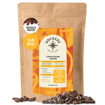 A 1-pound bag of Kochere Coffee Company’s Costa Rican Alajuela Medium Light Roast, with sweet apple and raisin notes, features an orange and yellow label and is single origin, specialty grade, and freshly roasted to order.