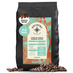 A 2lb bag of Kochere Coffee Company’s Horn of Africa Reserve Signature Espresso Blend, whole bean and medium-dark roast, with rich specialty coffee beans scattered at the base.