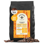 A 2lb bag of Kochere Coffee Costa Rican Alajuela Medium Light Roast by Kochere Coffee Company. This single-origin, specialty whole bean coffee features sweet apple and raisin notes, is roasted to order, and fresh beans are scattered near the bag.