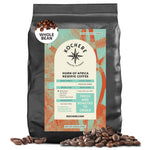A black bag of Kochere Coffee Company’s Horn of Africa Reserve Signature Espresso Blend—Medium-Dark Roast—is pictured with coffee beans in front. The label details the roast and grind for this premium blend.
