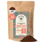 A 1 lb bag of Kochere Coffee Ethiopian Harrar Natural Medium Roast by Kochere Coffee Company, with fruity blueberry and dark chocolate notes, sits with ground coffee spilled in front.