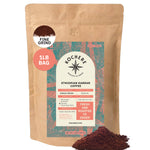 A 1lb bag of Kochere Coffee Company’s Ethiopian Harrar Natural Medium Roast, fine grind, with spilled grounds. The label highlights single origin, fruity blueberry and dark chocolate notes, fresh roasted to order with premium organic beans.