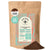 A 1lb bag of Kochere Coffee Ethiopian Sidamo Natural Medium-Light Roast by Kochere Coffee Company, with milk chocolate and fruity notes, stands upright with some coarse ground coffee gracefully spilled in front.