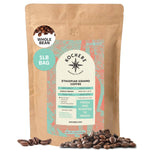 A 1-lb bag of Kochere Coffee Ethiopian Sidamo Natural Medium-Light Roast by Kochere Coffee Company, whole bean with milk chocolate and fruity notes, labeled and surrounded by fresh coffee beans.