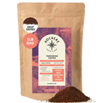 Kochere Coffee Company’s Tanzanian Mbeya AB, 1 lb bag, medium-light roast, drip grind—labeled "Fresh and roasted to order"—features vibrant pear, floral, and jasmine notes; some coffee grounds spilled at the base.[1lb][drip grind]