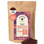 A 1lb bag of Kochere Coffee Company’s Tanzanian Mbeya AB Medium-Light Roast, featuring pear, floral, and jasmine notes, is freshly roasted to order with aromatic grounds shown in front.[1lb][fine grind]