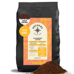 A 2lb bag of Kochere Coffee Company’s Colombian Medellin Single Origin Medium Roast, drip grind, with dried orange and berry notes, is shown with coffee grounds spilled in front.[2lb][drip grind]