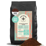 A 2-pound bag of Kochere Coffee Company's Ethiopian Sidamo Natural Medium-Light Roast features milk chocolate and fruity notes, with some ground coffee spilled in front of the bag.[2LB][drip grind]