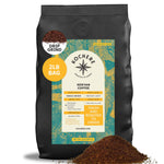 A 2lb bag of Kochere Coffee Kenyan Nyeri Embu AB Medium-Light Roast by Kochere Coffee Company, fruity and balanced, drip grind, with a teal and yellow label and a small pile of ground coffee in front. [2LB][drip grind]