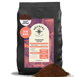 A 2-pound bag of Kochere Coffee Tanzanian Mbeya AB Medium-Light Roast by Kochere Coffee Company, featuring pear, floral, and jasmine notes in a single origin, drip grind with a pile of grounds displayed in front.