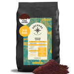 A 2lb bag of Kochere Coffee Kenyan Nyeri Embu AB, medium-light roast with lemon and blackberry notes, fine grind, sits with a pile of grounds in front. The label shows "Fresh and Roasted to Order." Brand: Kochere Coffee Company.