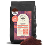 A 2lb bag of Kochere Coffee Company’s Tanzanian Mbeya AB Medium-Light Roast, featuring pear, floral, and jasmine notes, is freshly roasted to order with aromatic grounds shown in front.[2lb][fine grind]