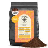 A 5 lb bag of Kochere Coffee Colombian Medellin Single Origin Medium Roast—dried orange and berry notes, coarse grind. Fresh grounds in front with detailed packaging and Fairtrade label from Kochere Coffee Company. [5lb][coarse grind]