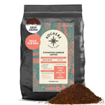 A 5lb bag of Kochere Coffee Company Ethiopian Harrar Natural Medium Roast, drip grind, with ground coffee spilled in front. The label highlights this fresh, single origin coffee with fruity blueberry and dark chocolate notes. Roasted to order.