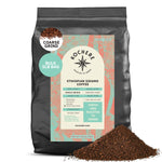 A 5lb bag of Kochere Coffee Company's Ethiopian Sidamo Natural Medium-Light Roast, with milk chocolate and fruity notes, is shown coarse ground and labeled single origin, featuring ground coffee in front of the package.