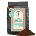A 5lb bag of Kochere Coffee Ethiopian Sidamo Natural Medium-Light Roast by Kochere Coffee Company, featuring milk chocolate and fruity notes, with freshly ground coffee displayed in front.