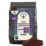A 5lb bag of Kochere Coffee Honduran Marcala Organic Medium Roast by Kochere Coffee Company, with caramel, spice, and brown sugar notes, sits in fine grind with a mound of coffee in front.