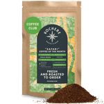 A brown bag labeled "Kochere Safari 'Coffee of the Month' Club" from Kochere Coffee Company sits with ground coffee in front, detailing roast level, single origin info, and club perks—ideal for your next fresh roasted coffee subscription.[12 oz][drip grind]