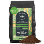 A 2 LB bag of Kochere Coffee Company’s Safari "Coffee of the Month" Club—Fresh Roasted Single Origin Subscription, medium roast, with a pile of ground coffee in front of the package. [2LB][coarse grind]