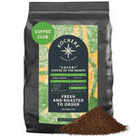 A 5 LB bag of Kochere Coffee Company’s Safari "Coffee of the Month" Club—Fresh Roasted Single Origin Subscription, medium roast, with a pile of ground coffee in front of the package. [5LB][coarse grind]