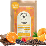 A bag of Kochere Coffee Colombian Medellin Single Origin Medium Roast by Kochere Coffee Company is surrounded by dried orange and berry accents, emphasizing its rich flavor notes and detailed label.