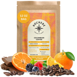 Bag of Kochere Single Origin Colombian medium roast coffee, displayed with rich chocolate, fresh oranges, and sweet mixed berries to represent its vibrant flavor profile. [12 oz][Whole Bean]
