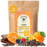 Bag of Kochere Single Origin Colombian medium roast coffee, displayed with rich chocolate, fresh oranges, and sweet mixed berries to represent its vibrant flavor profile. [1LB][Whole Bean]