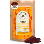 A 12oz bag of Kochere Coffee Company’s Costa Rican Alajuela Medium Light Roast, featuring sweet apple and raisin notes, is shown with aromatic fine coffee grounds displayed in front of the package.