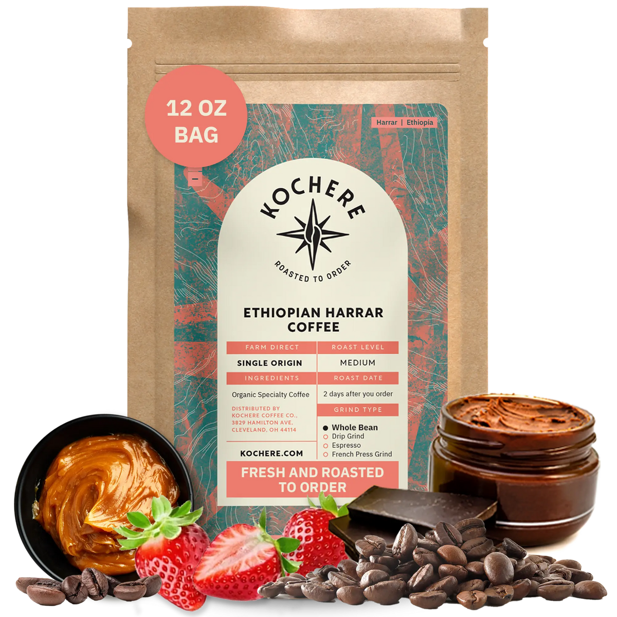 A 12 oz bag of Kochere Coffee Ethiopian Harrar Natural Medium Roast by Kochere Coffee Company stands upright, surrounded by coffee beans, strawberries, chocolate pieces, and a jar of chocolate spread.[12 oz][Whole Bean]
