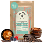 Bag of Kochere Single Origin Ethiopian Sidamo medium-light roast coffee, displayed with rich caramel, fresh berries, and dark chocolate to represent its decadent flavor profile. [12 oz][Whole Bean]