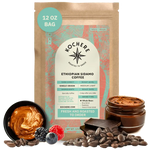 Bag of Kochere Single Origin Ethiopian Sidamo medium-light roast coffee, displayed with rich caramel, fresh berries, and dark chocolate to represent its decadent flavor profile. [12 oz][Whole Bean]