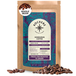 A 12oz bag of Kochere Coffee Company's Honduran Marcala Organic Medium Roast—caramel, spice, and brown sugar notes—with a labeled front showing roast level and origin, plus scattered beans; ideal for premium fair trade coffee lovers.
