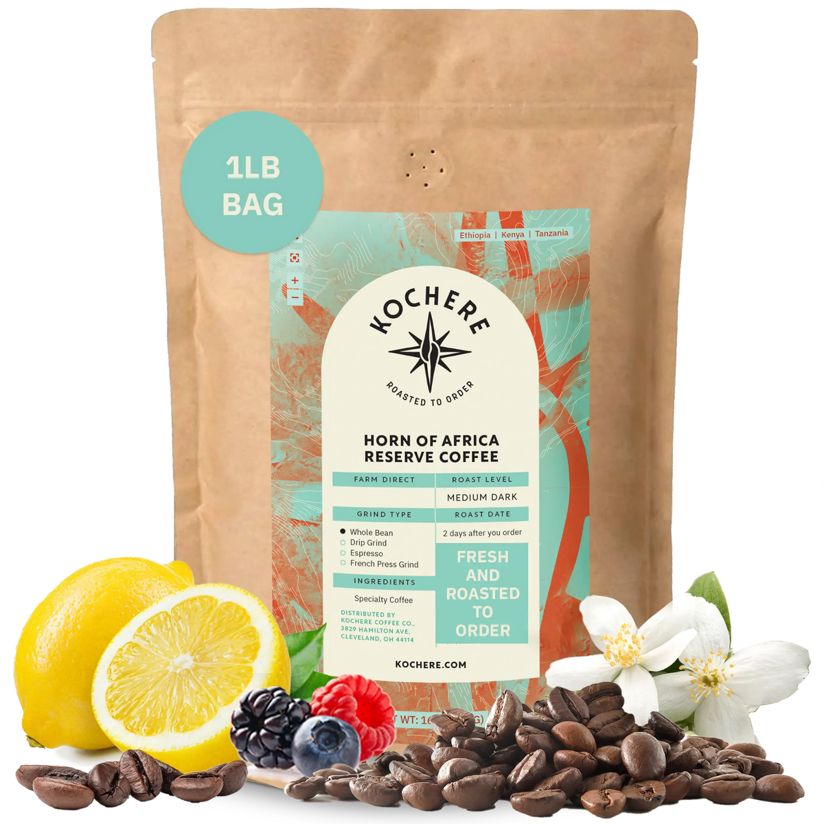 Kochere Horn of Africa Reserve medium-dark roast coffee, displayed with fresh lemons, berries, and white blossoms to represent its flavor profile. [1LB][whole bean]