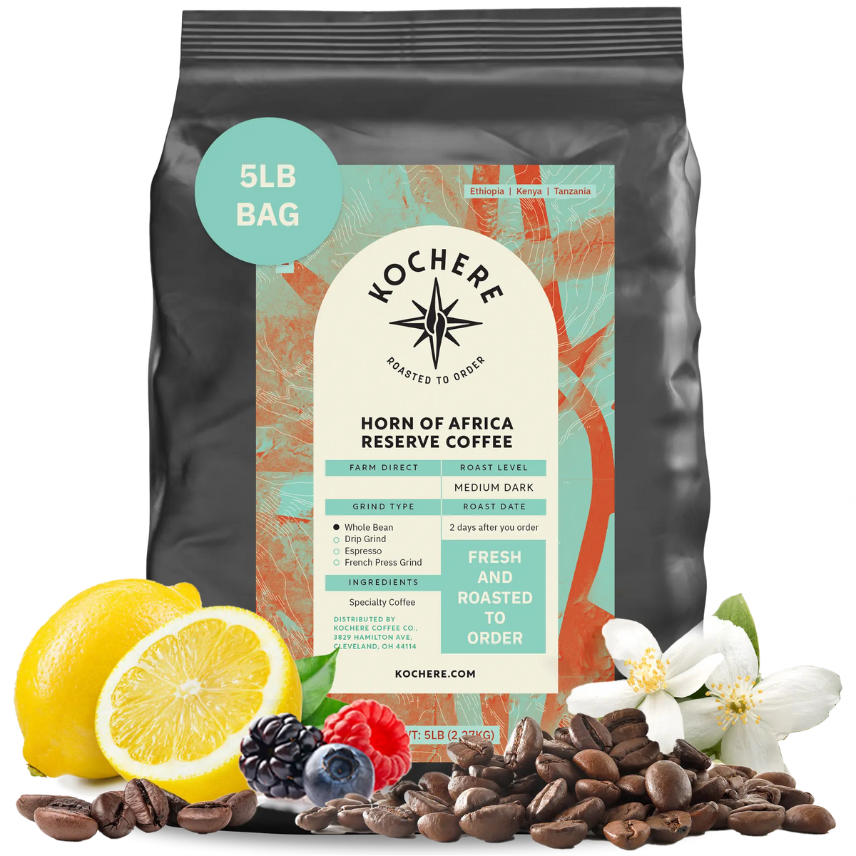 Kochere Horn of Africa Reserve medium-dark roast coffee, displayed with fresh lemons, berries, and white blossoms to represent its flavor profile. [5LB][whole bean]