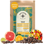 A bag of Kochere Coffee Kenyan Nyeri Embu AB Medium-Light Roast by Kochere Coffee Company, surrounded by coffee beans, citrus fruit and mixed fruit. The label highlights whole beans with lemon and blackberry notes and a fruity profile.