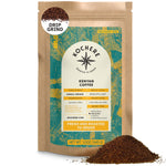 A 12oz bag of Kochere Coffee Kenyan Nyeri Embu AB by Kochere Coffee Company, a medium-light roast with a fruity, balanced, bright cup for drip grind; some ground coffee is shown in front of the bag.[12 oz][drip grind]