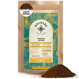 A 12oz bag of Kochere Coffee Kenyan Nyeri Embu AB by Kochere Coffee Company, a medium-light roast with a fruity, balanced, bright cup for drip grind; some ground coffee is shown in front of the bag.