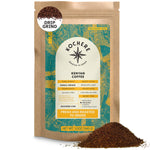 A 12oz bag of Kochere Coffee Company’s Kenyan Nyeri Embu AB, a single origin medium-light roast with lemon and blackberry notes, is shown in drip grind with ground coffee spilled in front.
