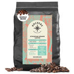 A 5lb bag of Kochere Coffee Ethiopian Sidamo Natural Medium-Light Roast by Kochere Coffee Company, with a turquoise and coral label showing roast level and flavor notes of milk chocolate and fruit, plus beans scattered at the base.