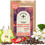 A bag of Kochere Coffee Tanzanian Mbeya AB Medium-Light Roast by Kochere Coffee Company is pictured with pear, strawberry, coffee beans, and white flowers—reflecting its bright, floral jasmine notes.