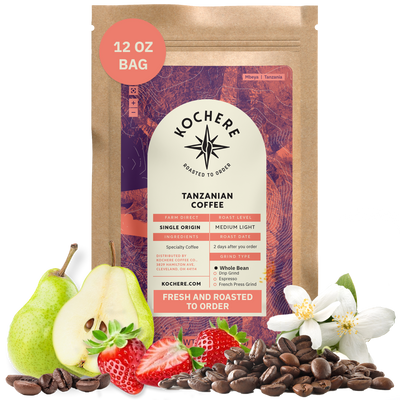 Bag of Kochere Single Origin Tanzanian medium-light roast coffee, displayed with fresh pears, sweet strawberries, and white blossoms to represent its crisp and aromatic flavor profile. [12 oz][Whole Bean]