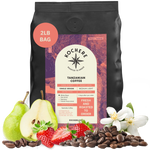 Bag of Kochere Single Origin Tanzanian medium-light roast coffee, displayed with fresh pears, sweet strawberries, and white blossoms to represent its crisp and aromatic flavor profile. [2LB][Whole Bean]