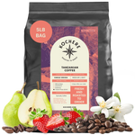 Bag of Kochere Single Origin Tanzanian medium-light roast coffee, displayed with fresh pears, sweet strawberries, and white blossoms to represent its crisp and aromatic flavor profile. [5LB][Whole Bean]