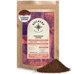 A 12oz bag of Kochere Coffee Tanzanian Mbeya AB Medium-Light Roast—featuring pear, floral, and jasmine notes—labeled as coarse grind with some coffee spilled beside it; the bag displays its origin, roast profile, and company website.[12 oz][coarse grind]