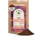 A 12oz bag of Kochere Coffee Tanzanian Mbeya AB Medium-Light Roast—featuring pear, floral, and jasmine notes—labeled as coarse grind with some coffee spilled beside it; the bag displays its origin, roast profile, and company website.