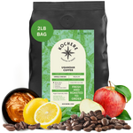 Bag of Kochere Single Origin Ugandan medium roast coffee, displayed with rich caramel, fresh lemons, and crisp red apples to represent its sweet and vibrant flavor profile. [2LB][Whole Bean]